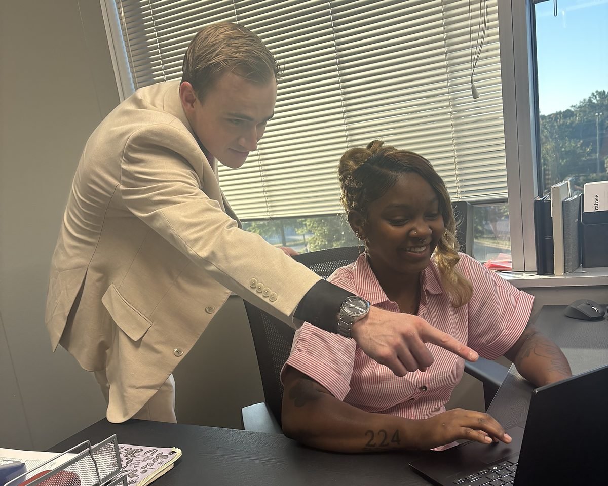 Daniel Foltz coaching a team member at her desk