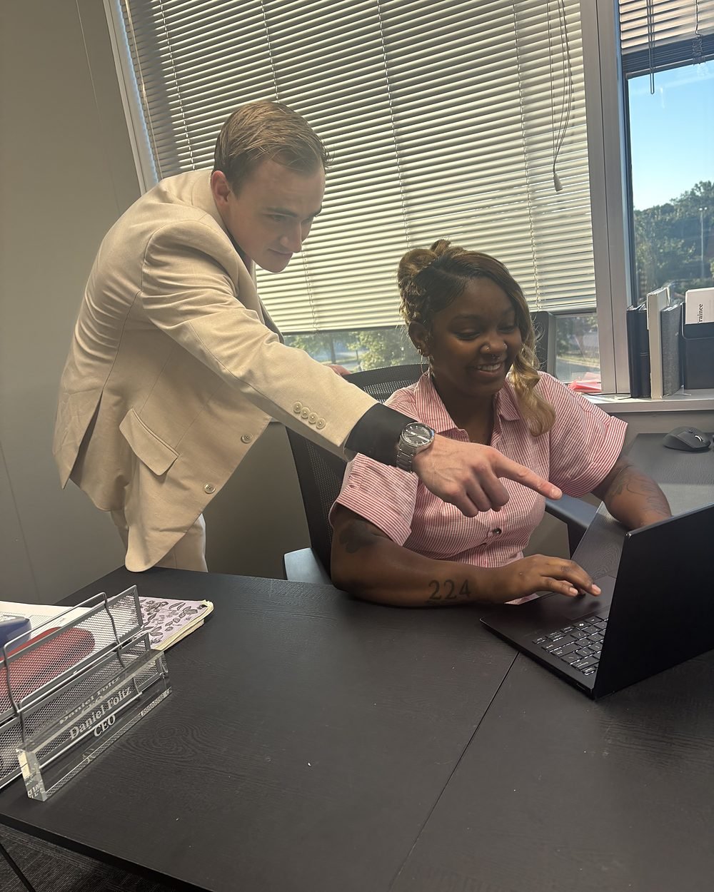 Daniel Foltz coaching a team member at her desk