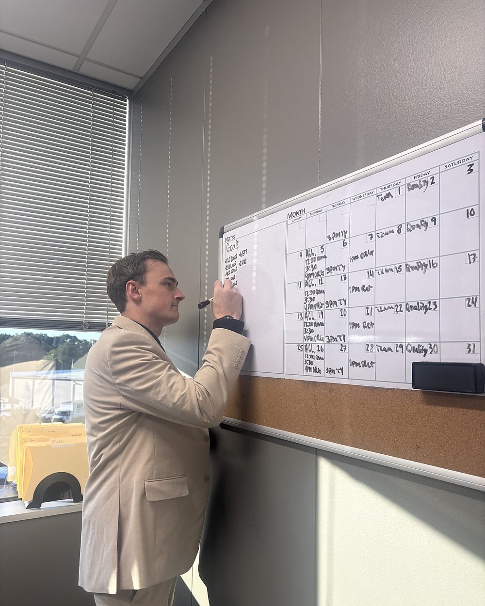 Daniel Foltz, CEO, planning the month on the office whiteboard
