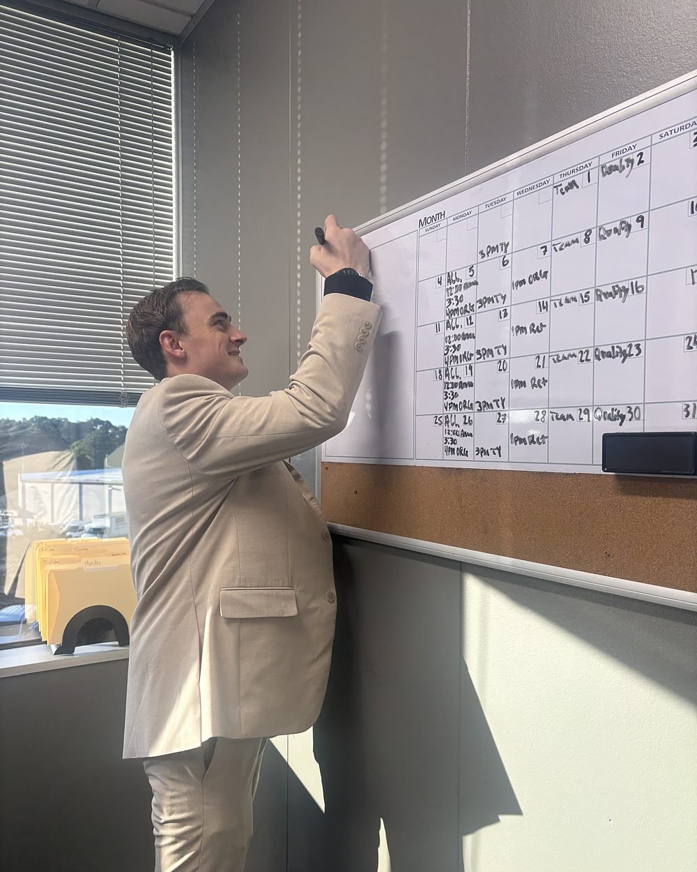 Daniel Foltz, CEO, writing up the month on the office whiteboard